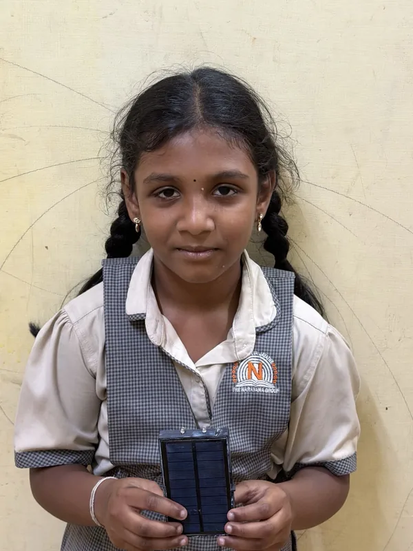 A student holding the solar flashlight she received